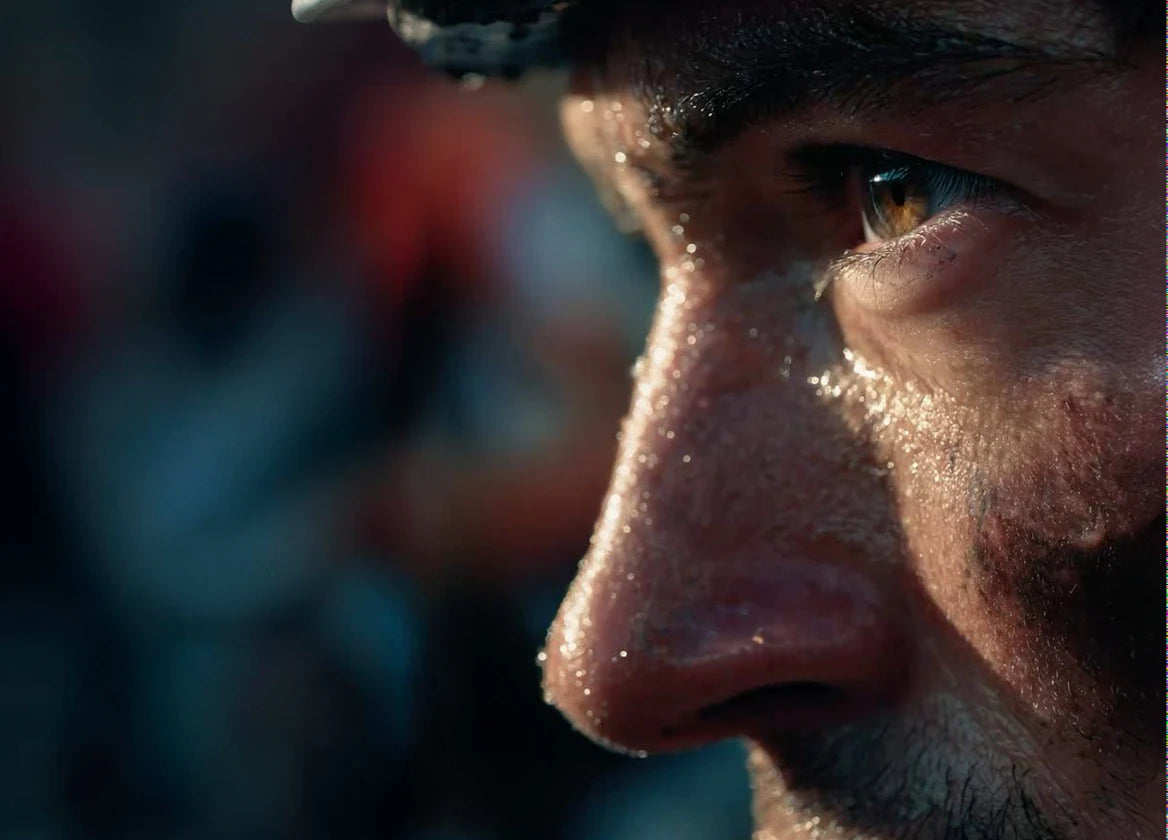 Close-up of an athlete's sweat-beaded face