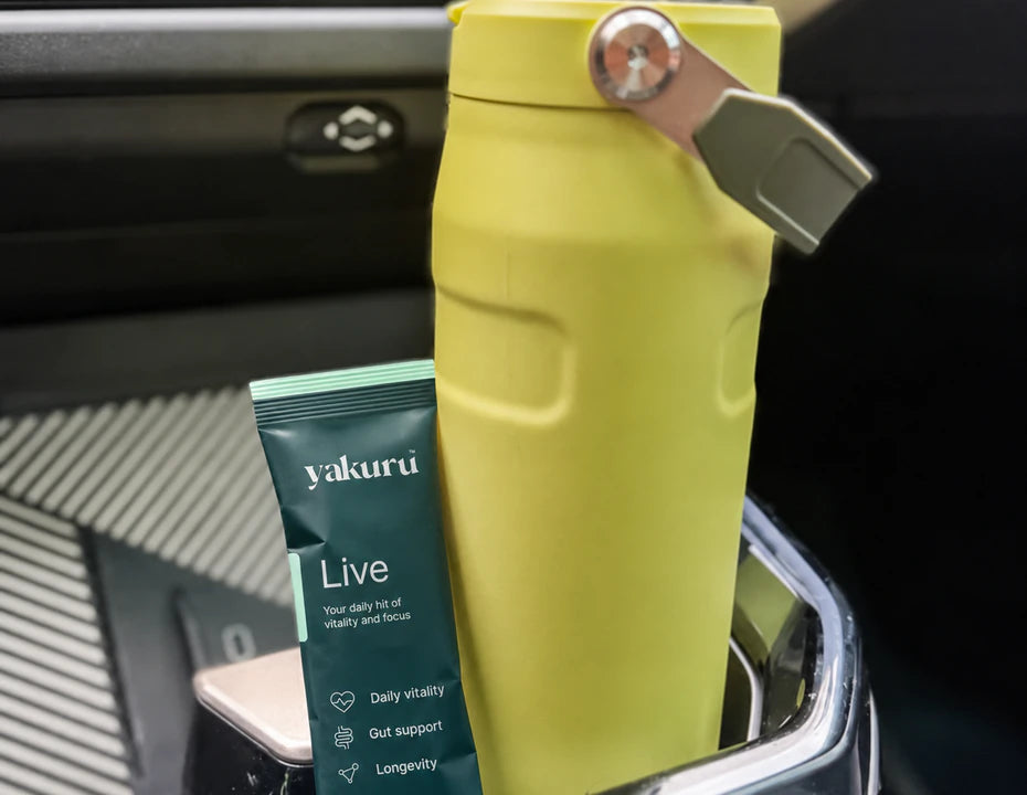 Yakuru Live sachet beside a water bottle in a car