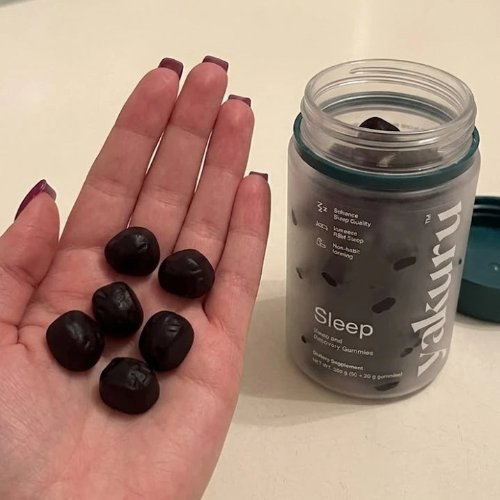 Yakuru Sleep gummies in a hand beside the jar